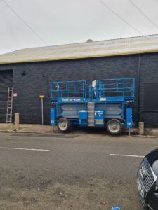 Painter and Decorator Nottingham │Scissor Lift carrying out external painting works of a commercial property.