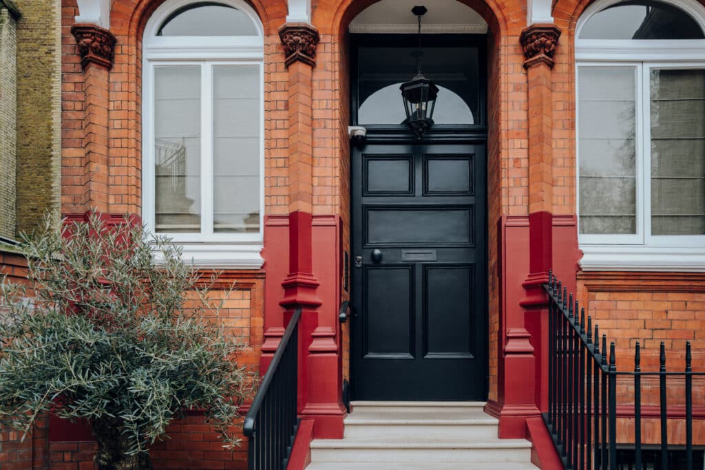 Freshly painted black front door on a red brick house in Leicester or Nottingham.