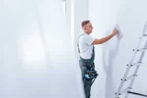 Painter smoothing the wall at a Leicestershire property