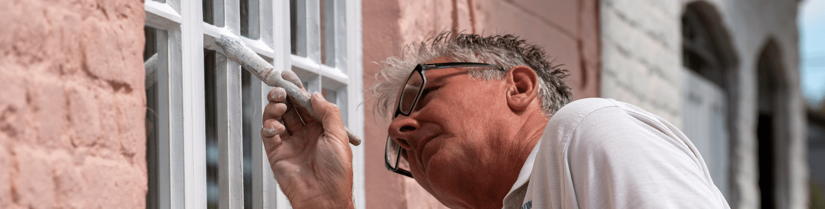 A close-up of a paintbrush being used by a decorator in Leicester, highlighting the tools of the trade.