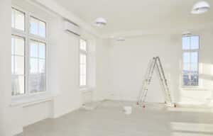 empty commercial interior space being painted