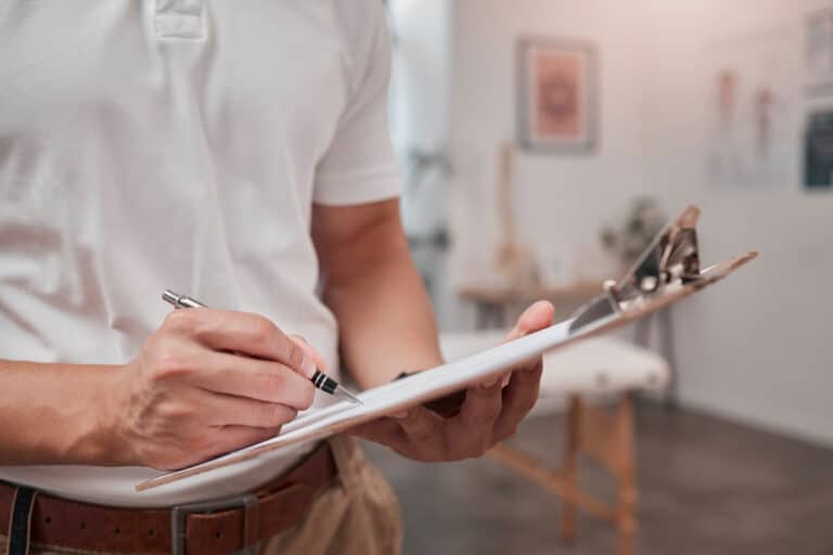 Decorator completing a quote for a customer on a clipboard